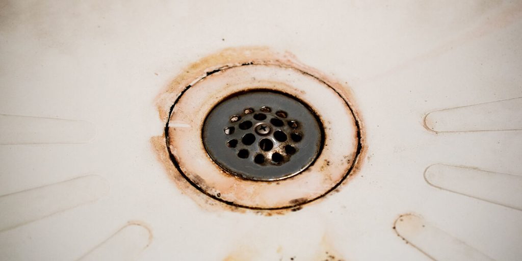 how to clean a shower drain that can't be removed